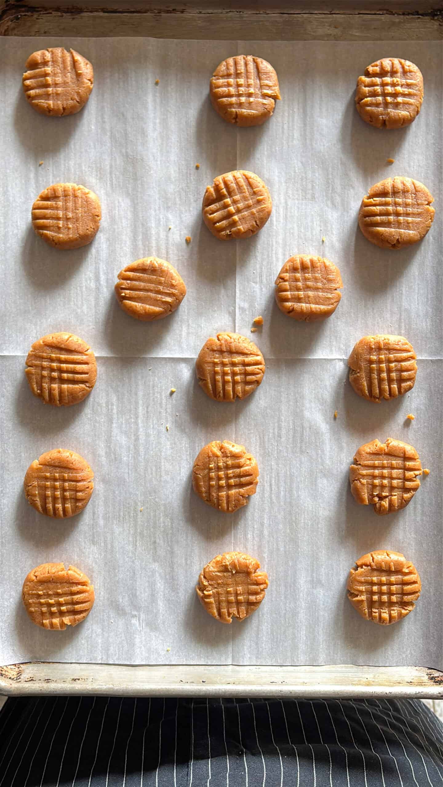 Uncooked peanut butter cookies on a baking sheet.