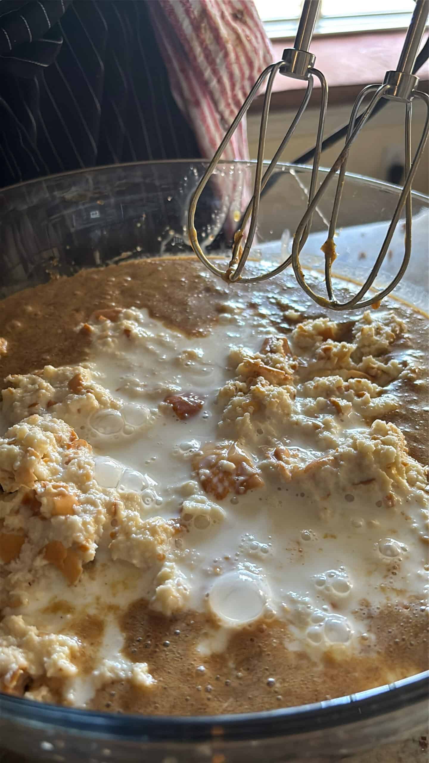 Bread added to custard base in a bowl.
