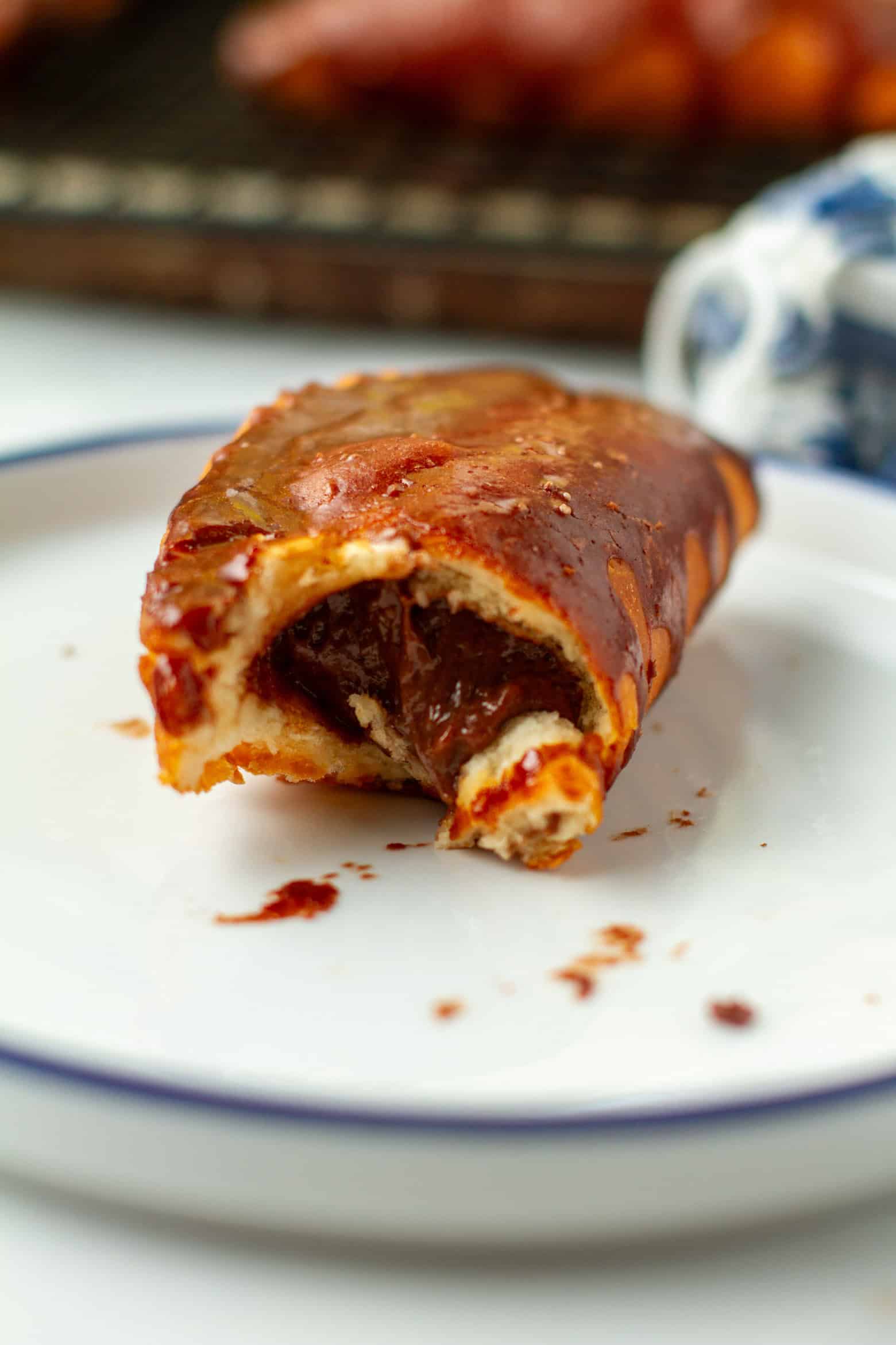 Bitten chocolate hand pie in a hand.