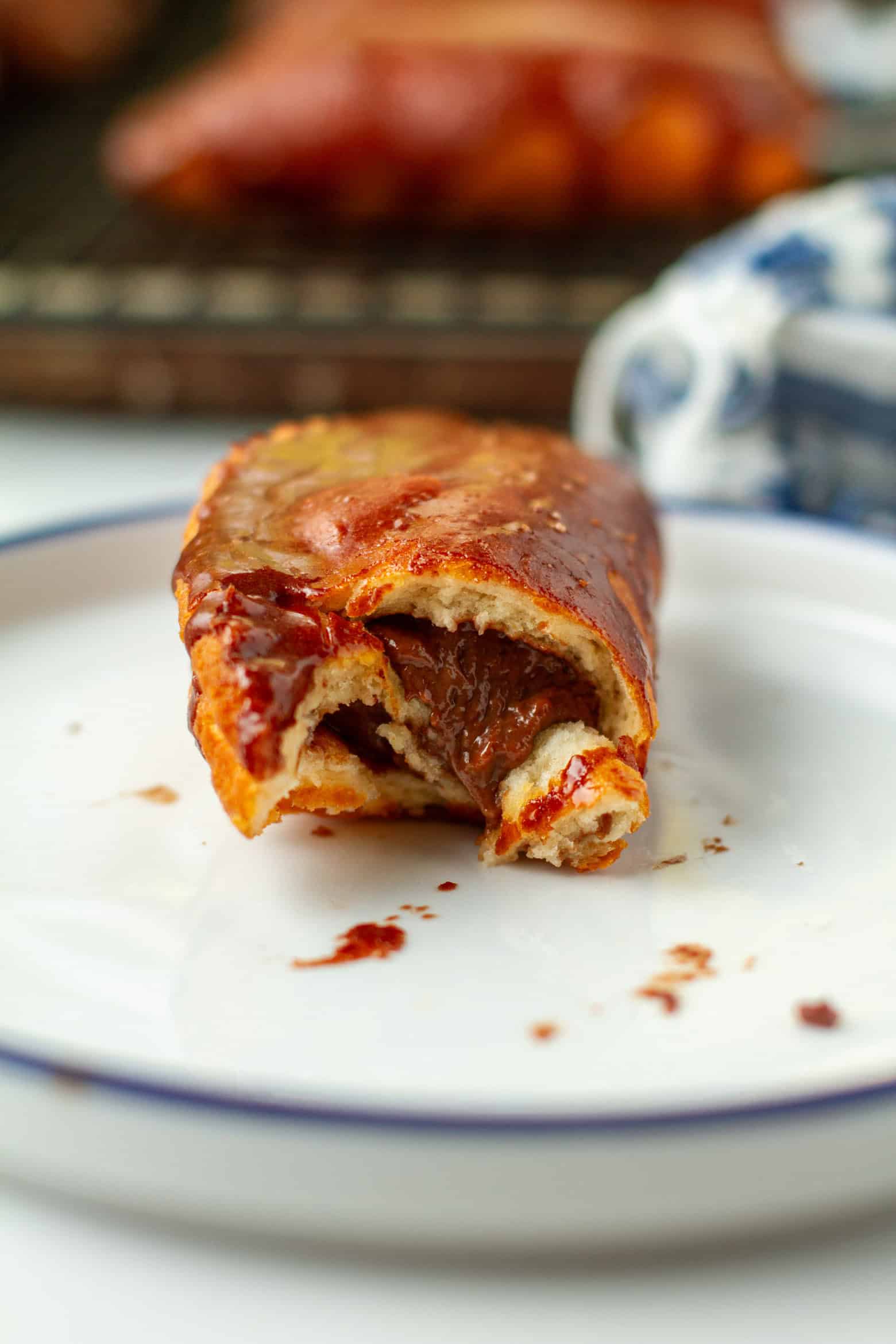 Bitten chocolate hand pie in a hand.