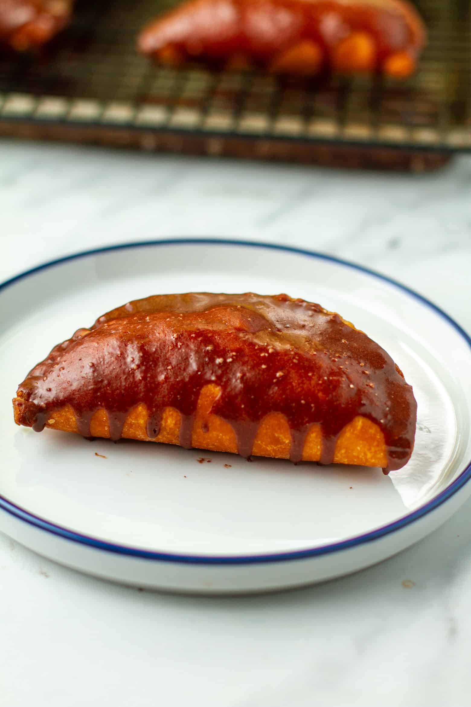 Chocolate hand pie on a plate.