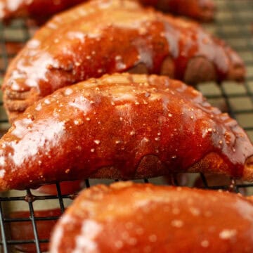 Chocolate glazed chocolate hand pies on a wire rack.