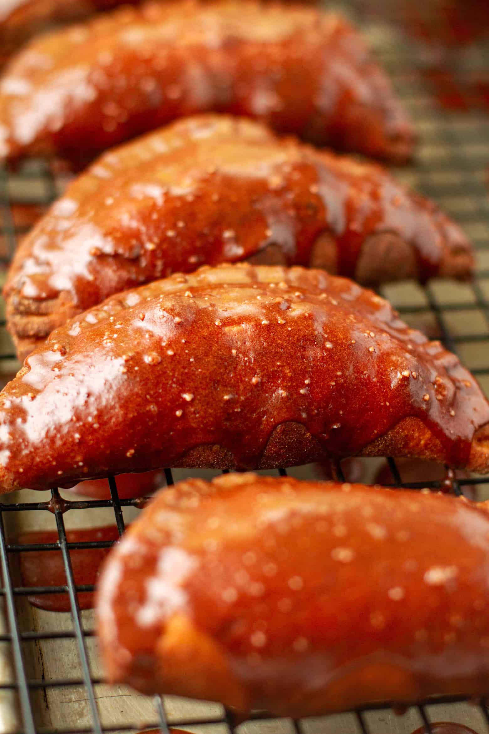 Chocolate glazed chocolate hand pies on a wire rack.