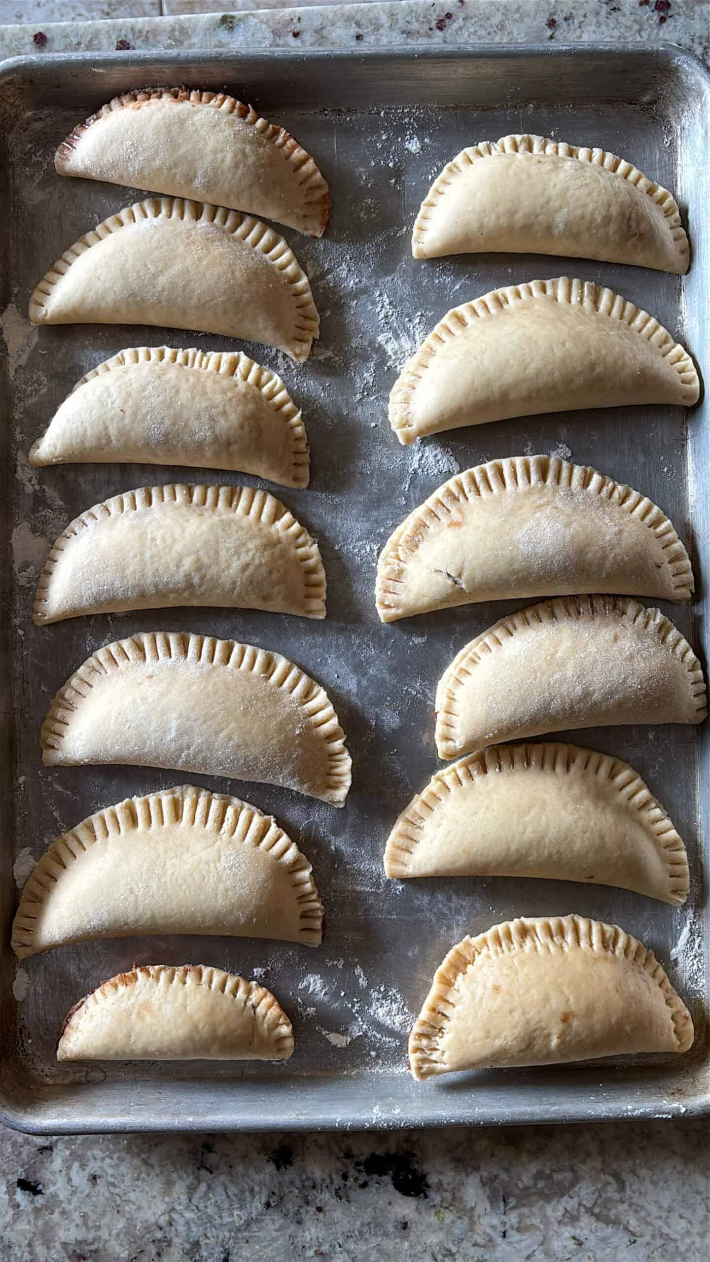 Finished chocolate hand pies on a baking sheet.