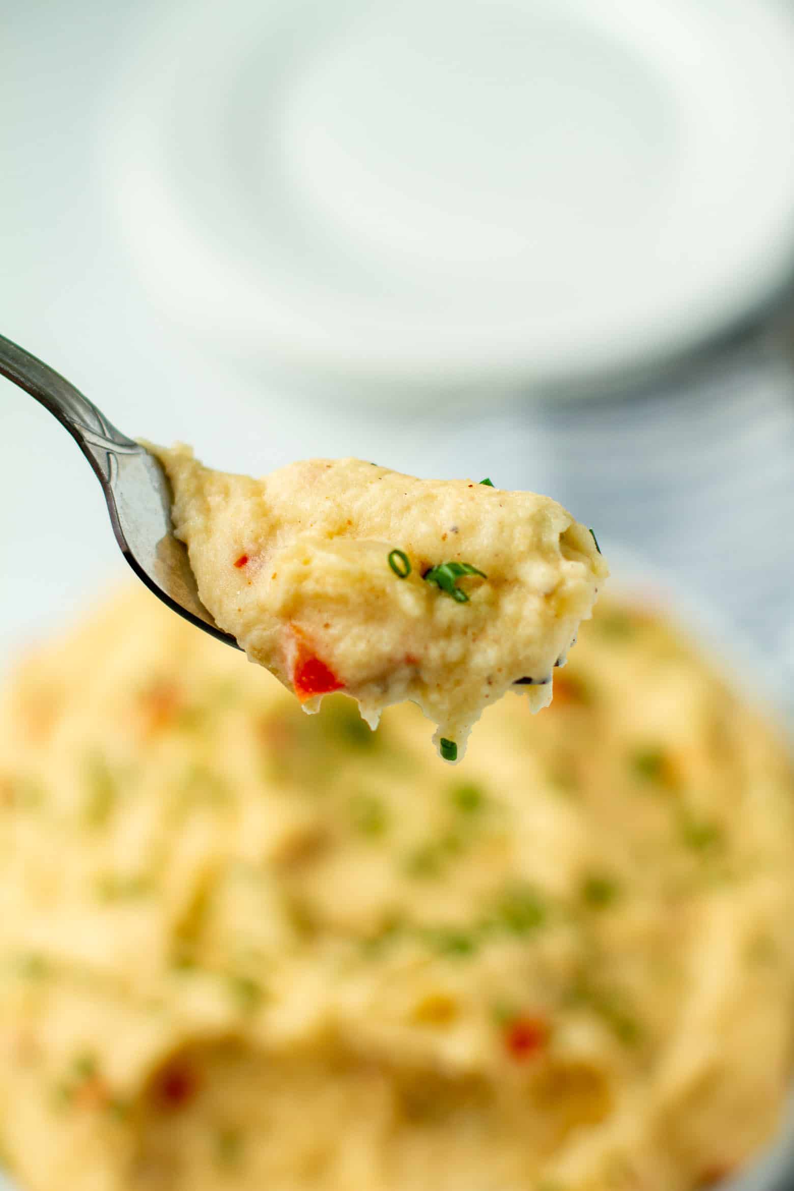 Dirty mash potatoes on a fork.