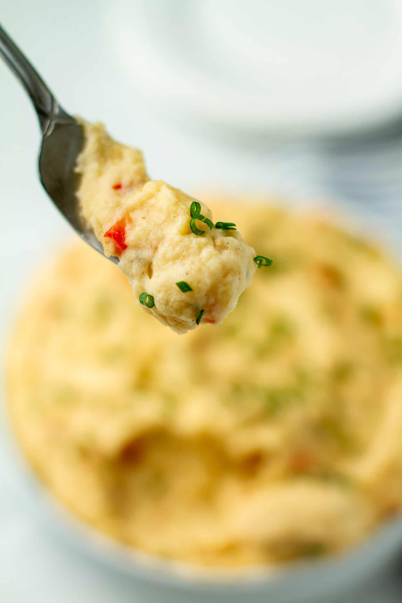 Dirty mash potatoes on a fork.