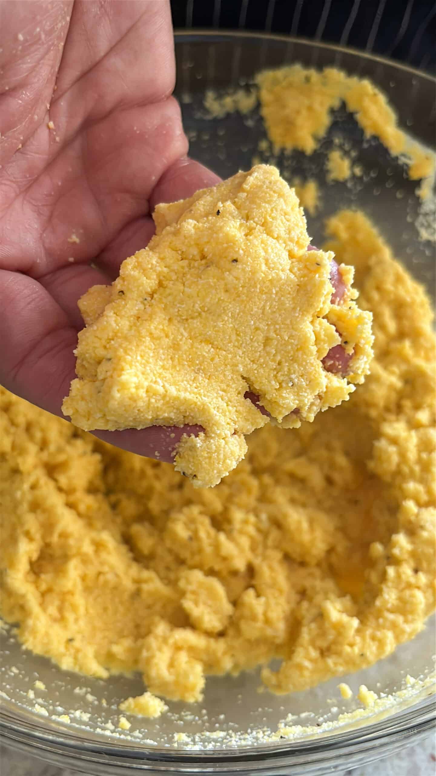 Hot water cornbread dough in someone's hand.