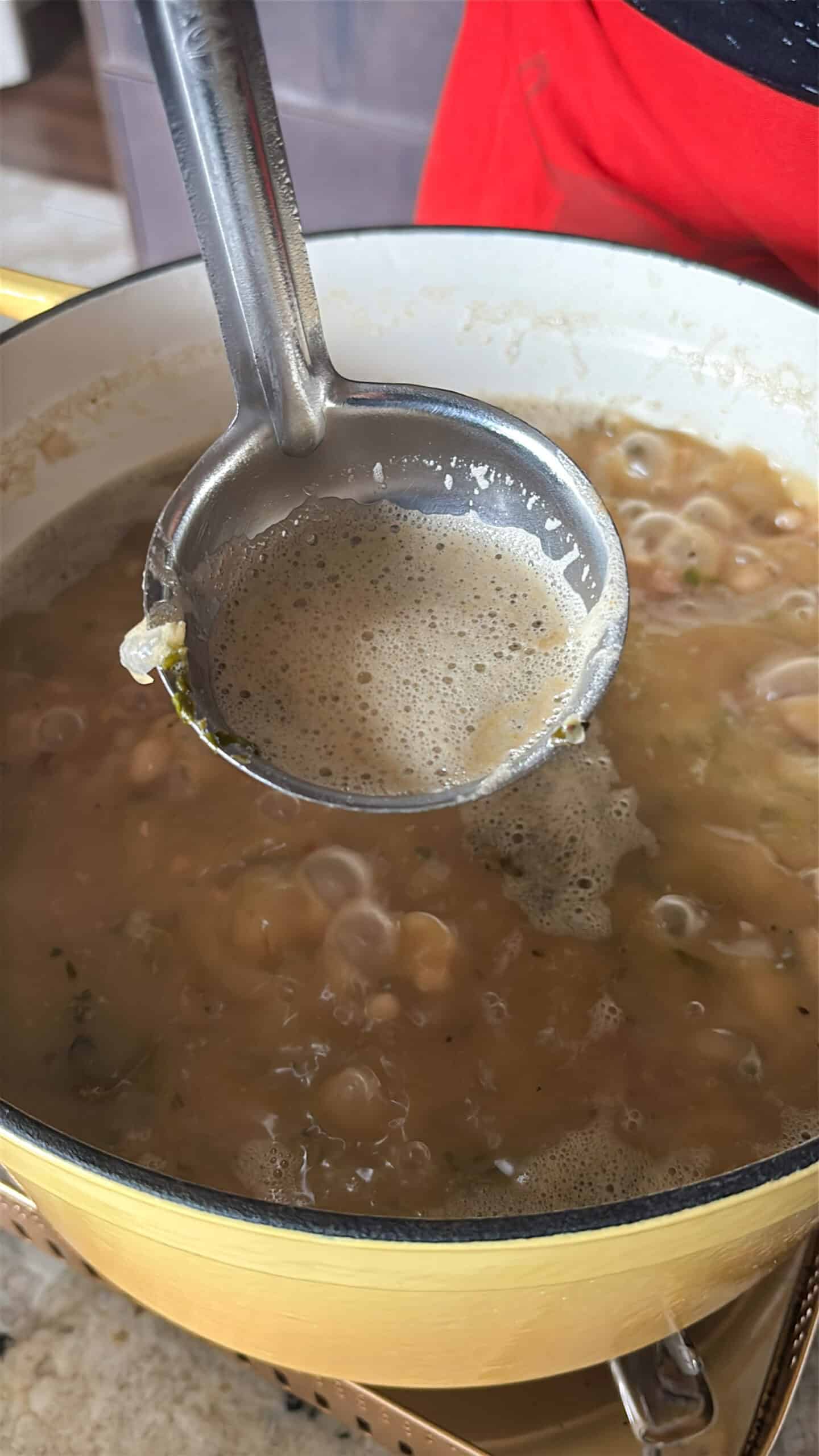 Foam being skimmed away from pot.