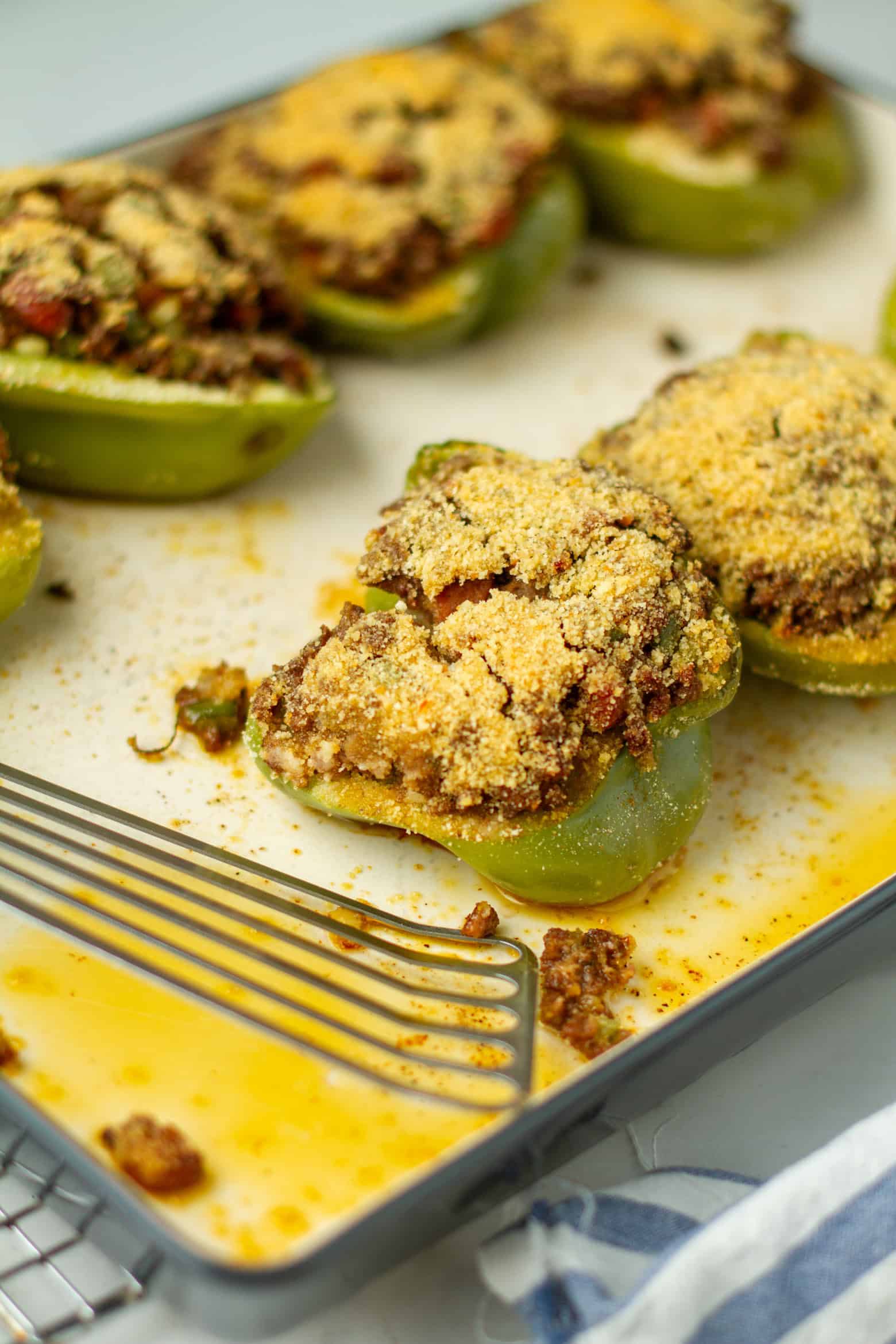 Cooked stuffed bell peppers on a baking sheet.
