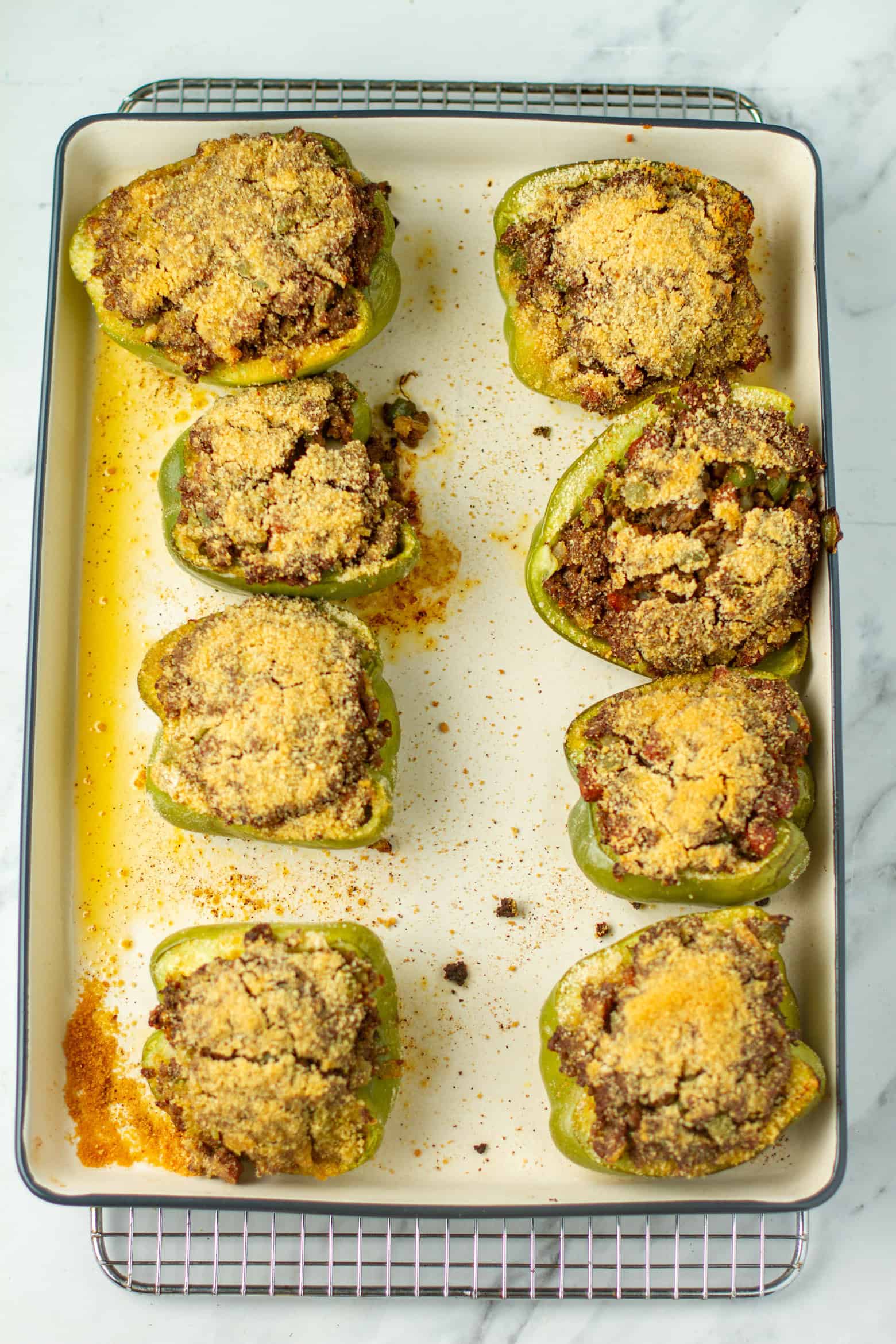 Cooked stuffed bell peppers on a baking sheet.