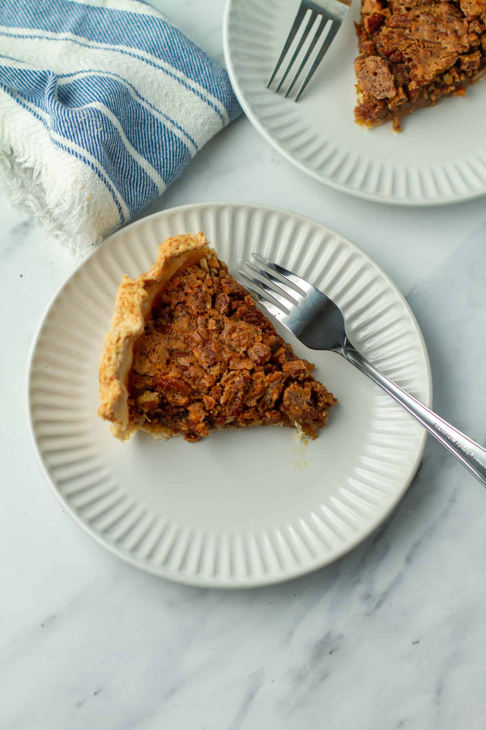 Slice of pecan pie on a plate.