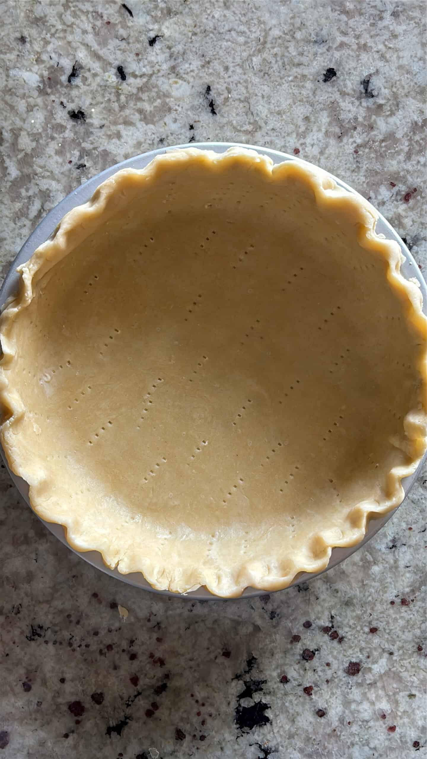 Crimped pie crust in pie pan.