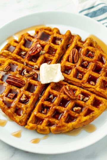 Pumpkin Pecan Waffle on a plate.