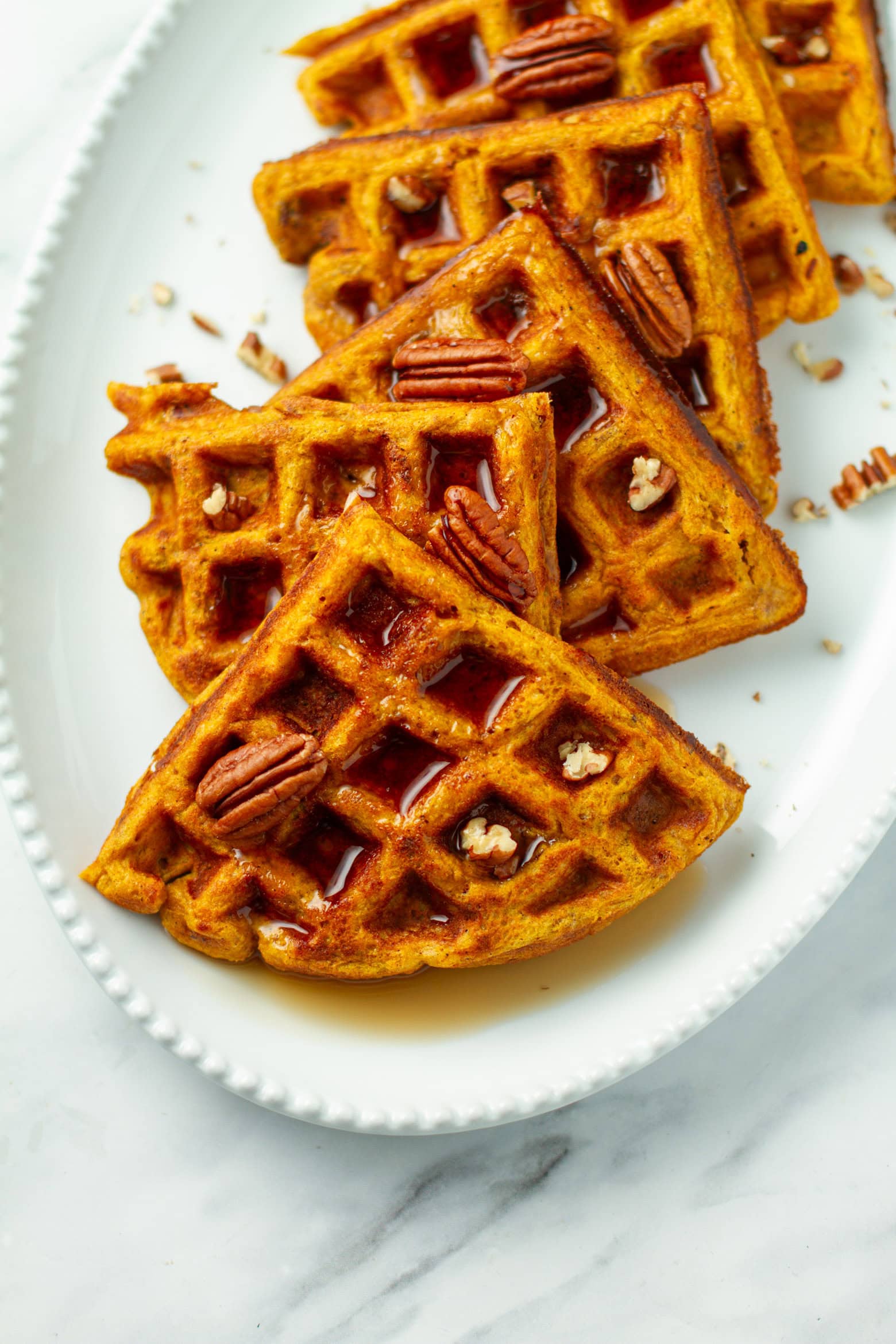 Pumpkin Pecan Waffles on a platter.