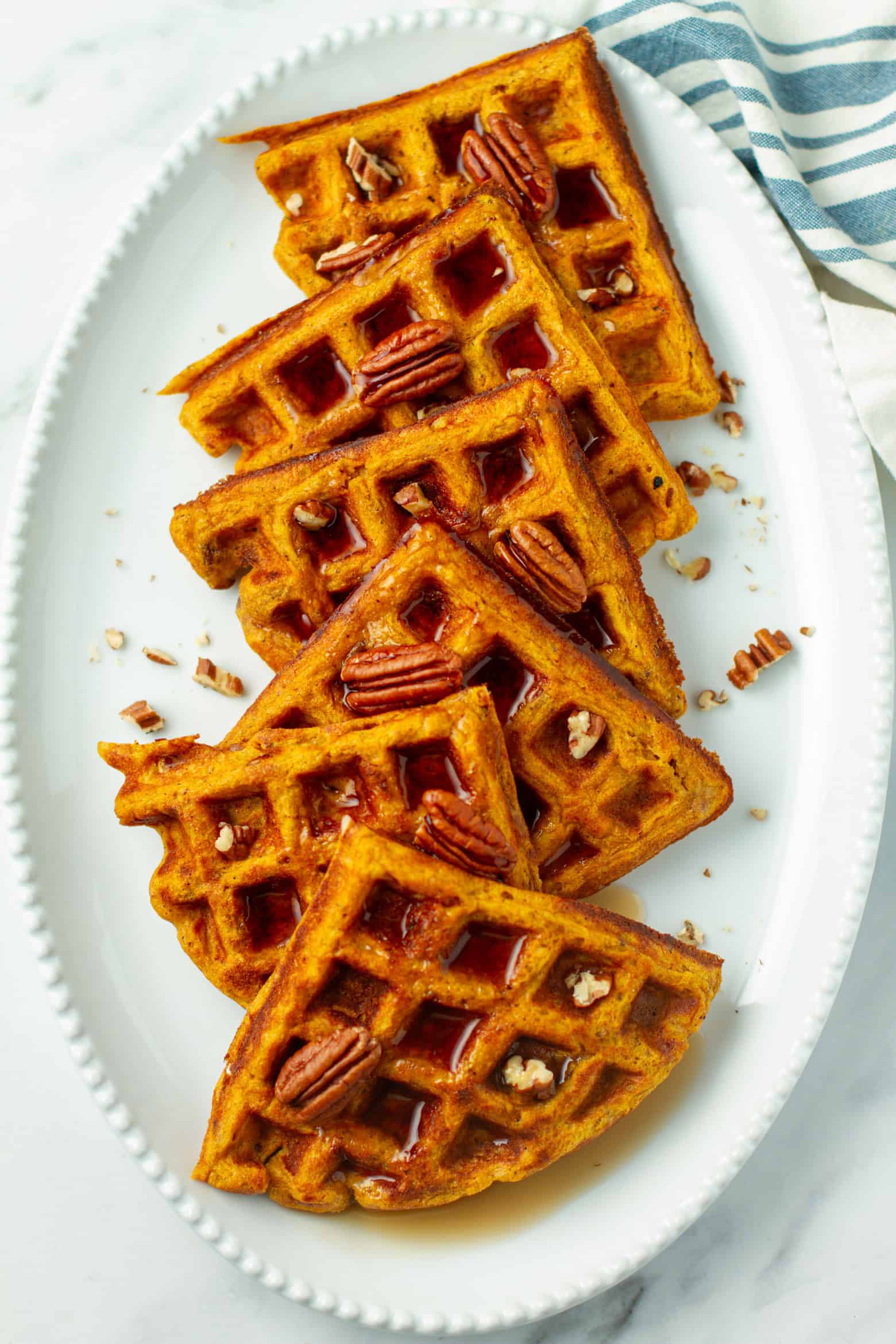 Pumpkin Pecan Waffles on a platter.