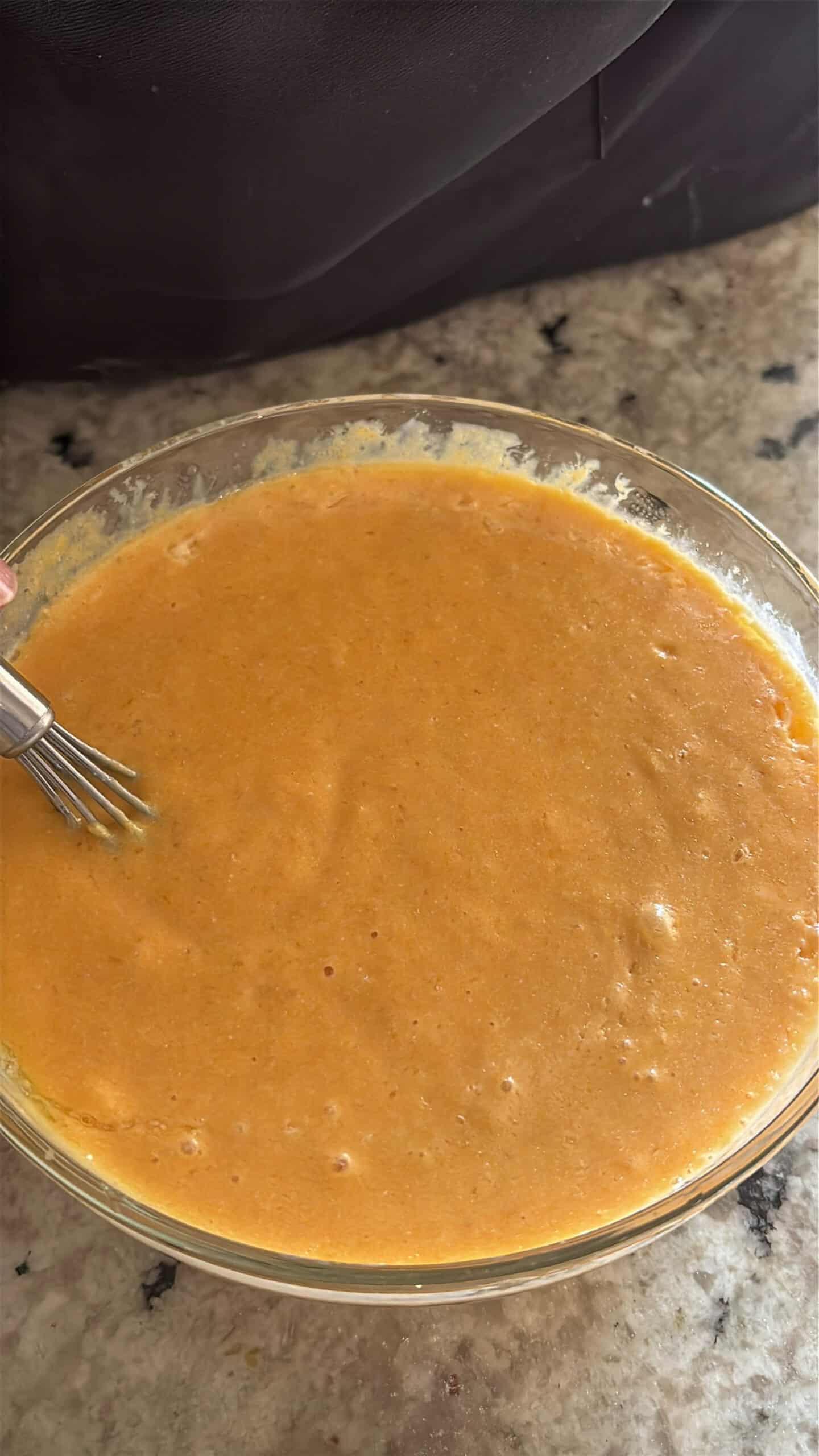 Pumpkin pecan waffles wet ingredients in a bowl.