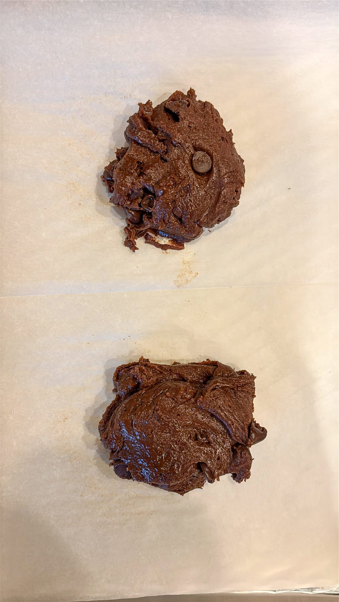Raw chocolate cookie dough on a baking sheet.