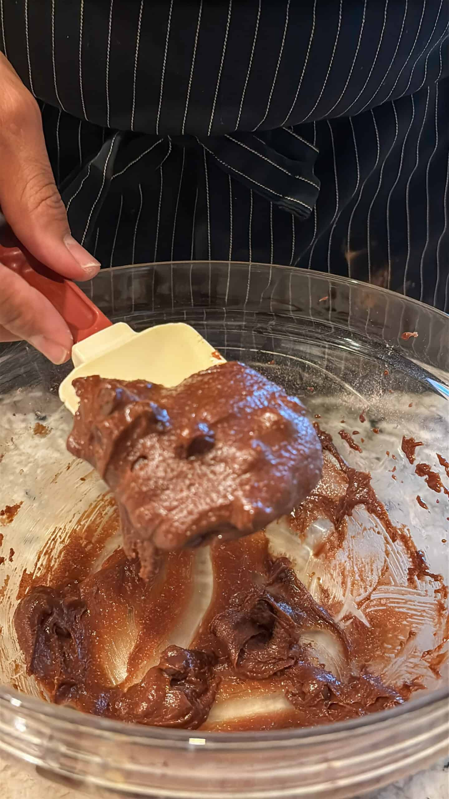 Chocolate cookie batter on a spatula to show the consistency.
