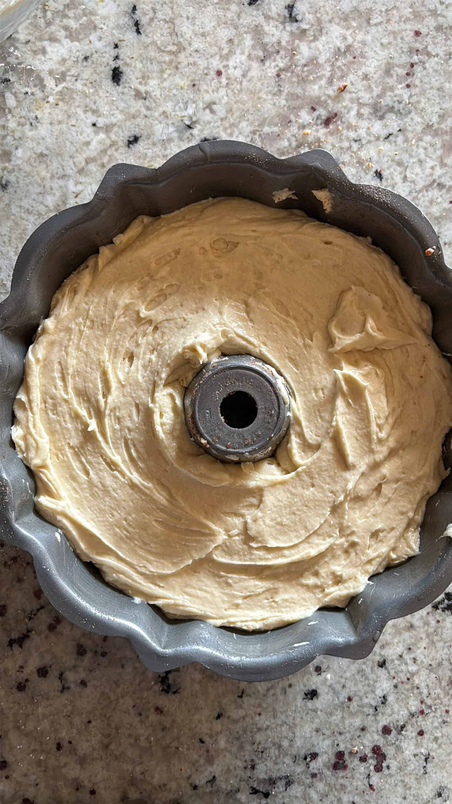 Final layer of cake batter added to bundt pan.