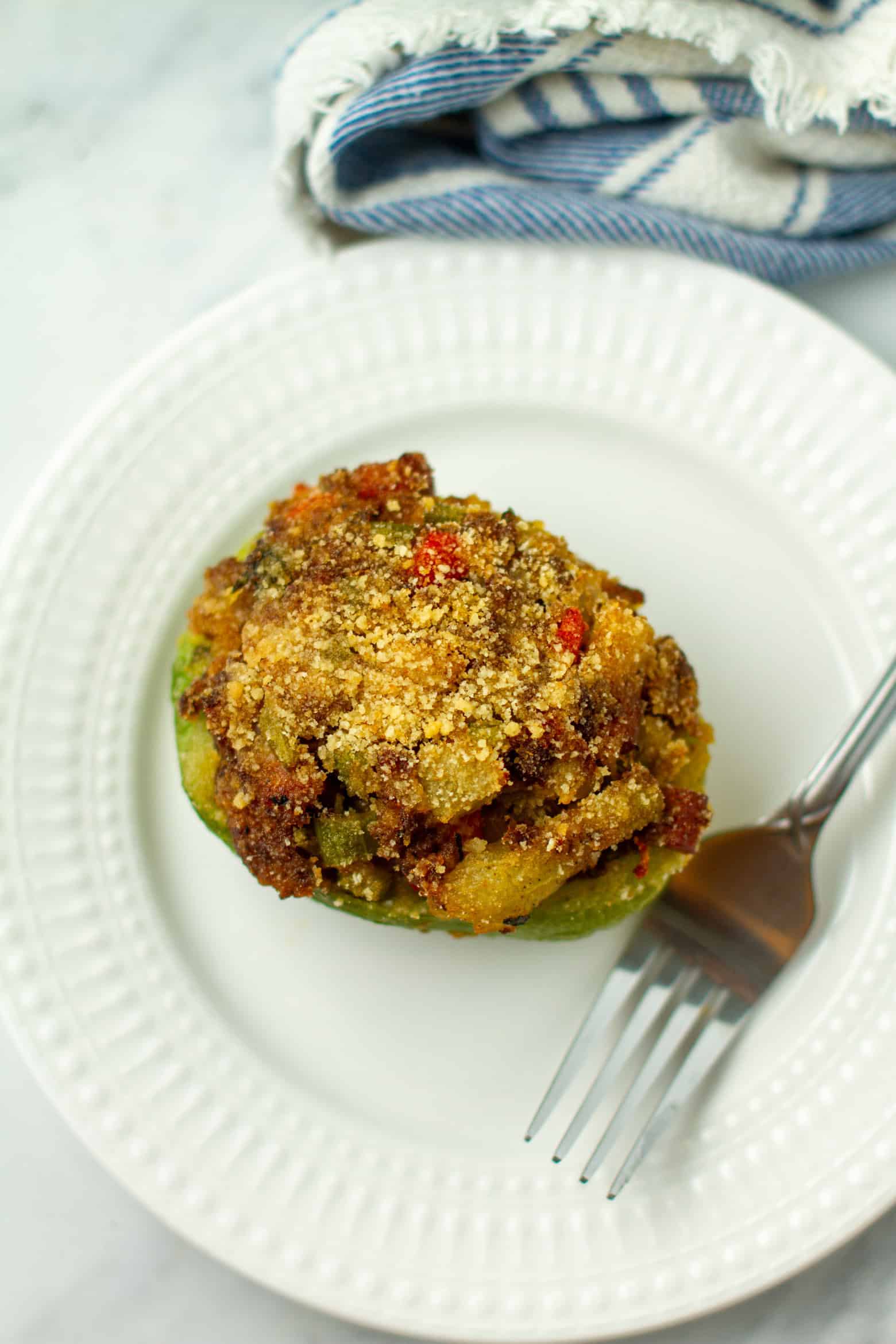 Cooked Stuffed mirliton on a plate.