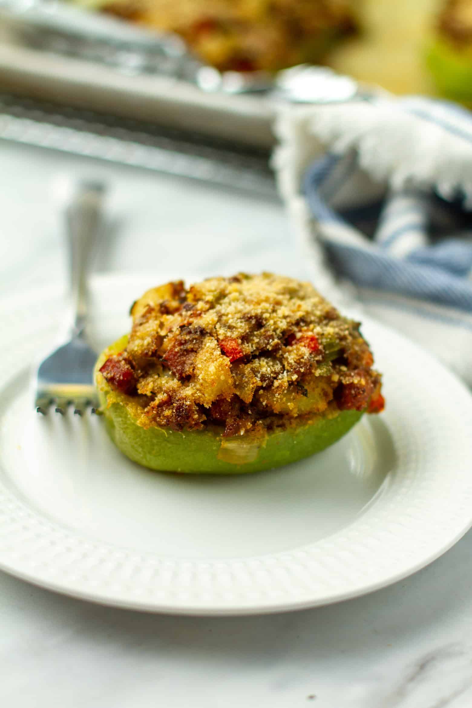 Stuffed mirliton on a plate with a fork.