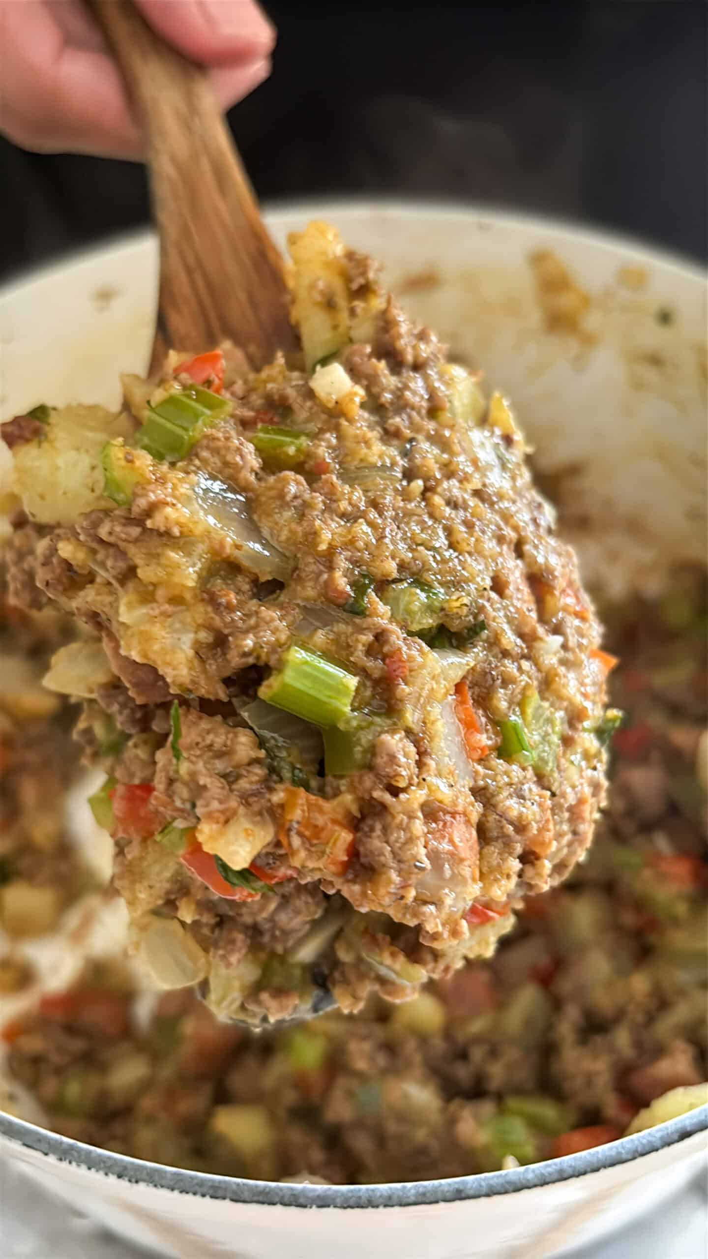 A close up of the mirliton stuffing on a spoon.