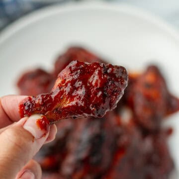 BBQ Chicken wing being held.