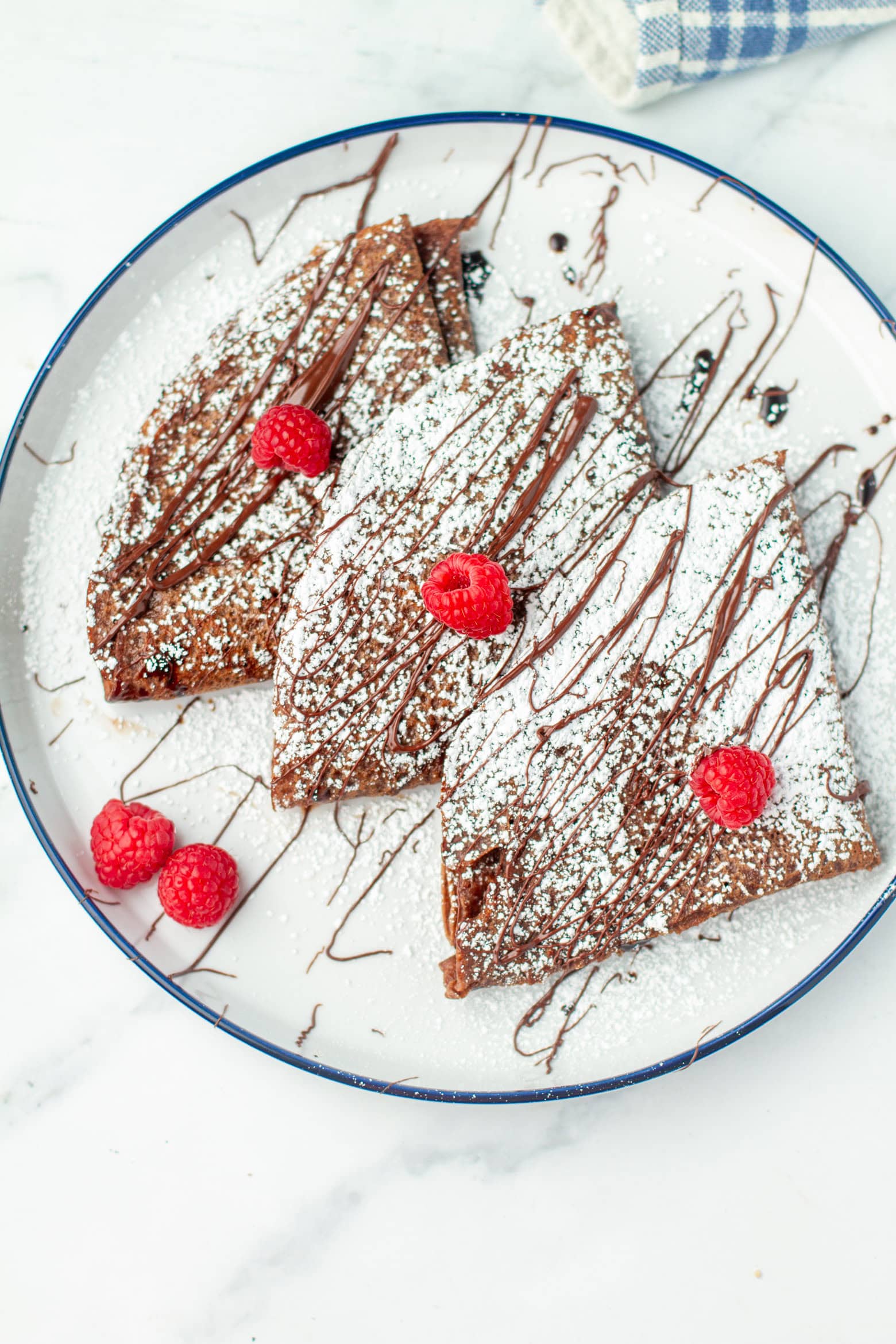 Chocolate crepes on a plate.
