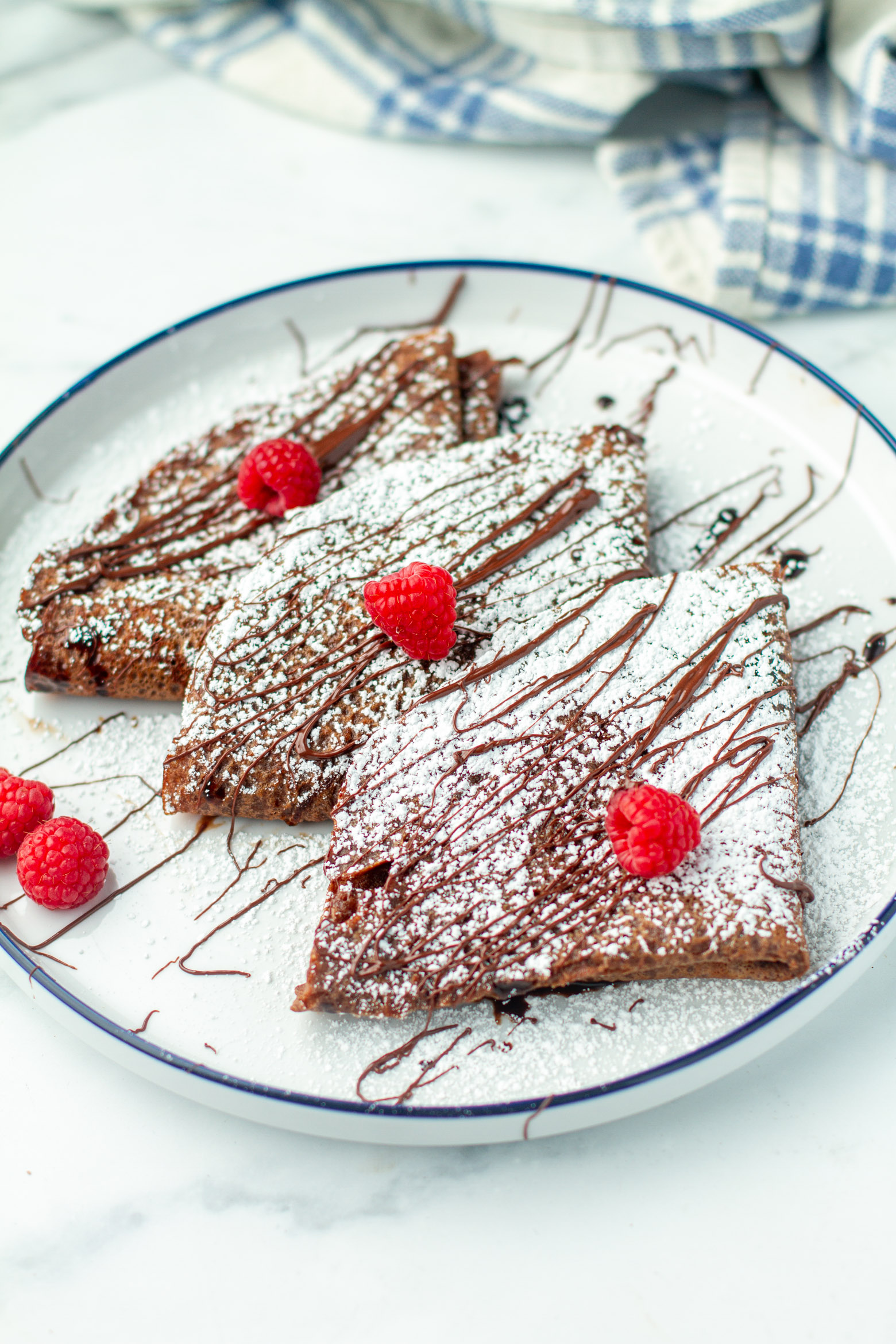 Chocolate crepes on a plate.