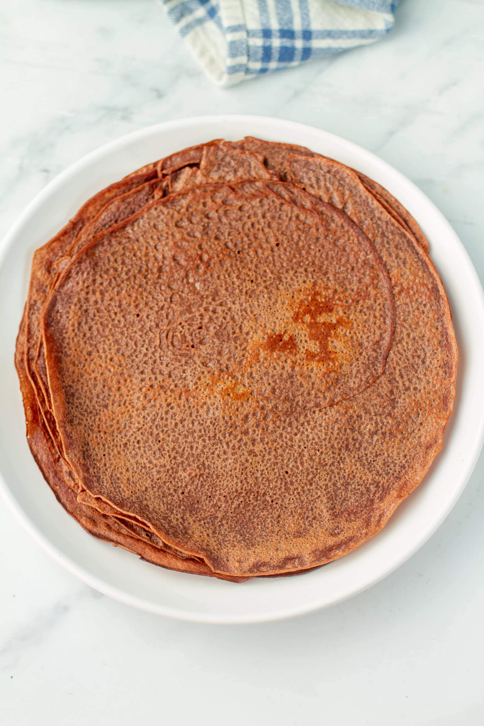 Chocolate crepes on a plate.