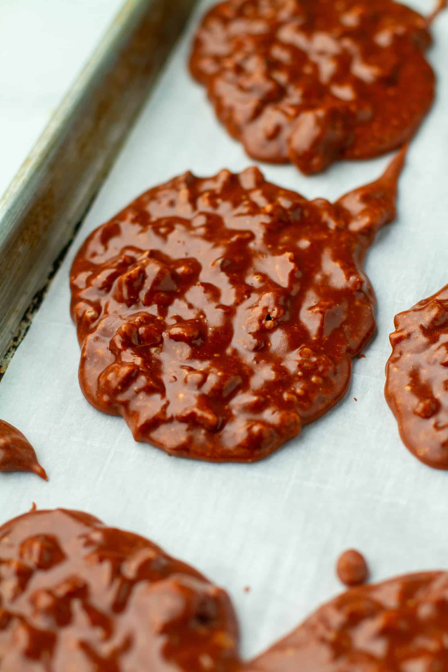 Chocolate Pralines cooling on a baking sheet.