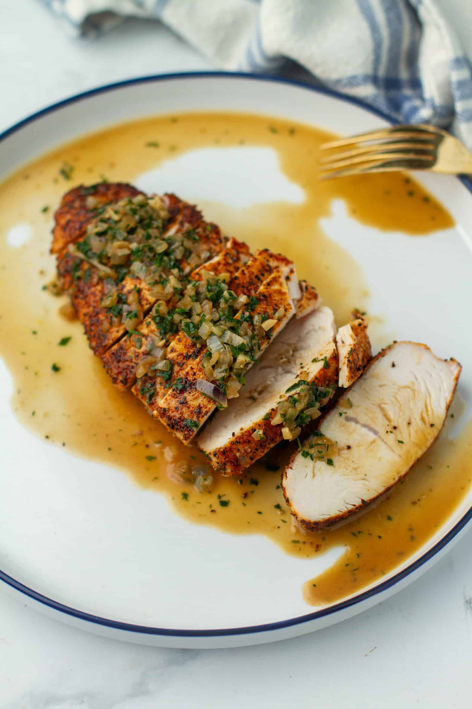 Oven Roasted Turkey Tenderloin on a plate with sauce.