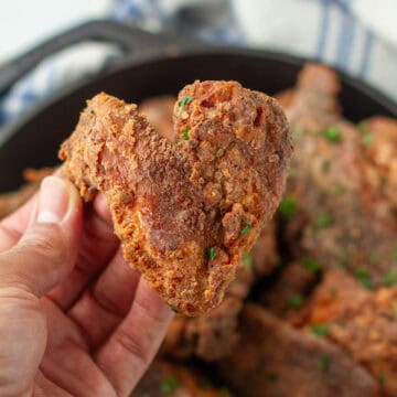 Fried chicken being held in a hand.
