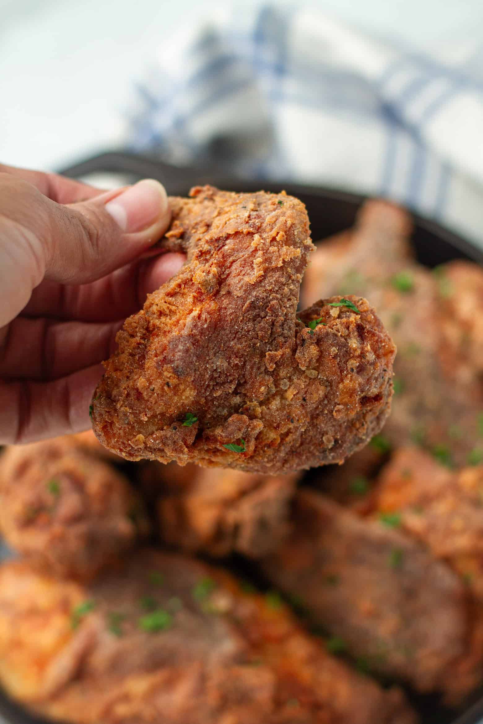 Fried chicken being held in a hand.