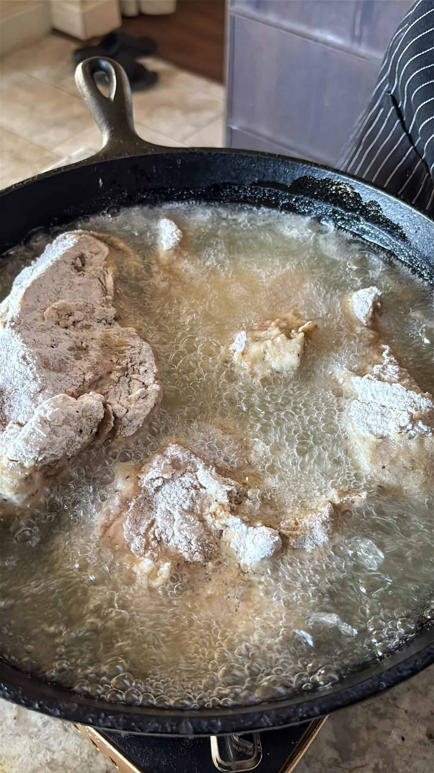 Chicken frying in hot oil.