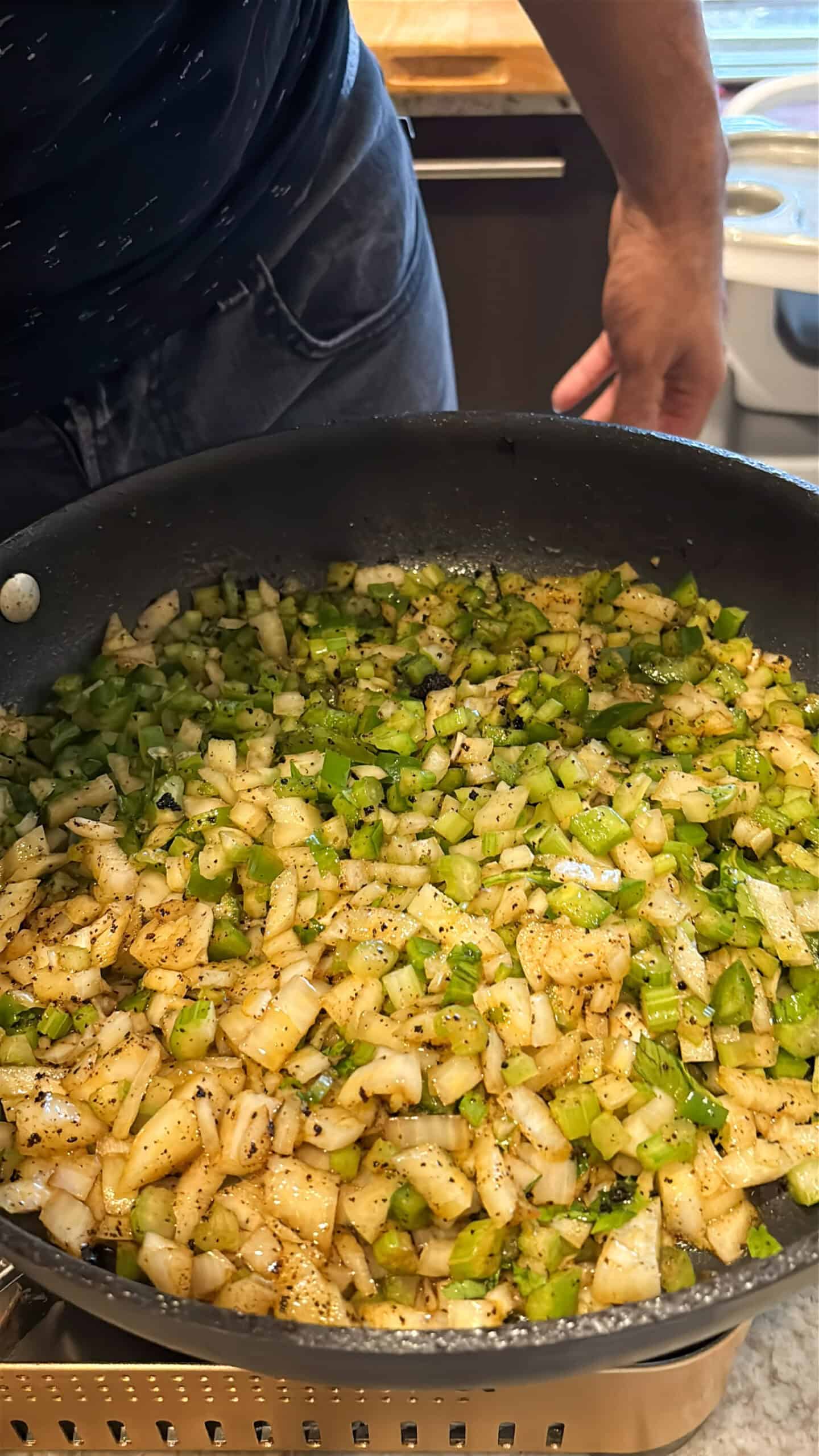 Vegetables cooking in a skillet.