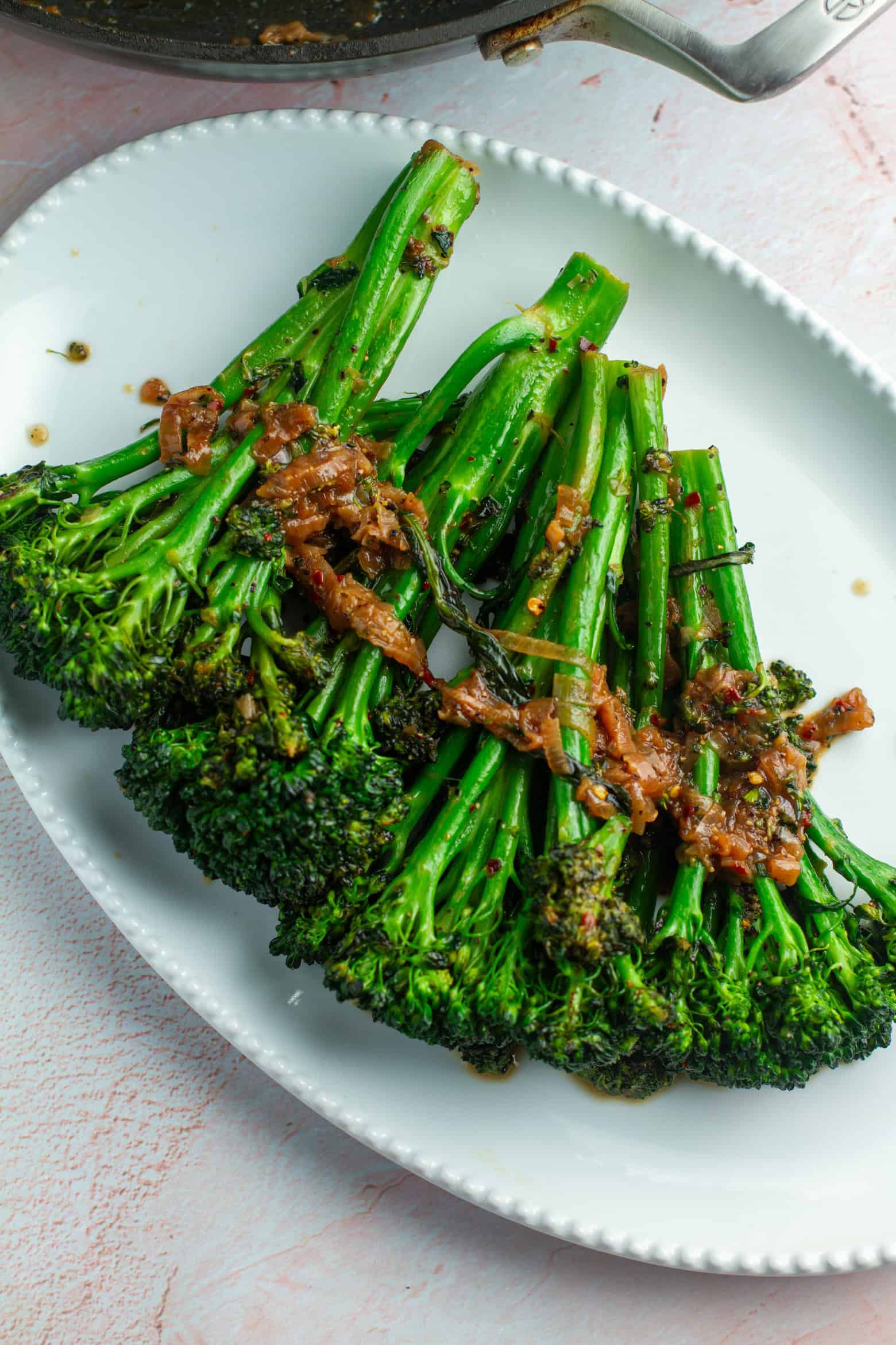 overhead shot of sauteed broccolini on a platter.