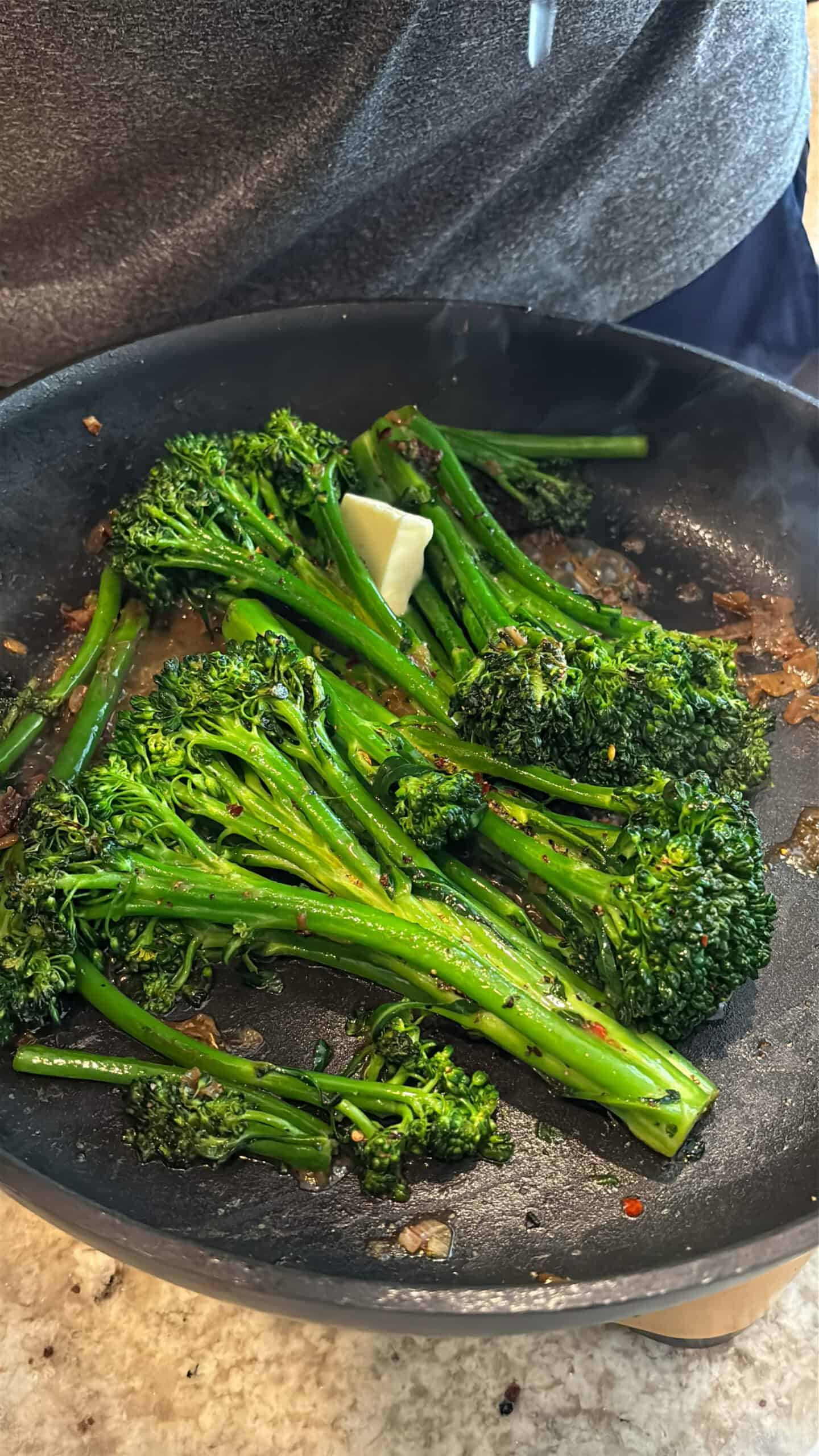 Lemon juice and butter added to cooked broccolini.
